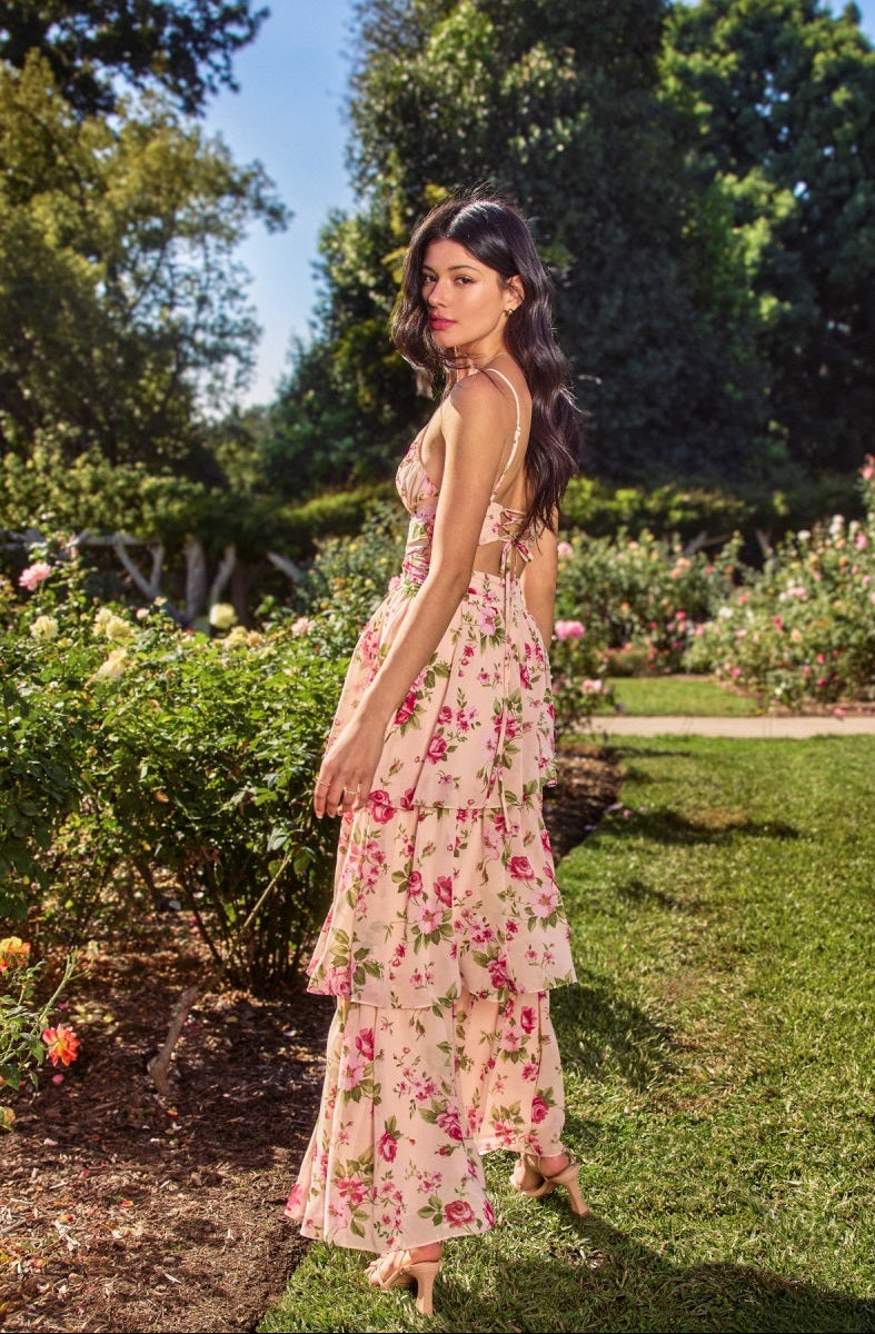 Woman in a floral dress standing in a garden